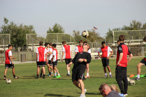 Coppell coach Chad Rakestraw headers the ball to himself while the team takes penalty kicks in their practice on Thursday in Midland, Texas. Rakestraw and the Cowboys trained for an hour in a half in preparation for their regional semifinal matchup with El Paso Socorro.