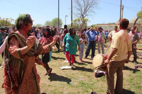 Holi attendees dance to traditional music at the DFW Hindu Temple on Sunday. According to Houston Holi 2016, “The sound of music and drums resonates through the air and everyone dances in celebration throwing color on their beloved, just as Lord Krishna did with his lover Radha.” 