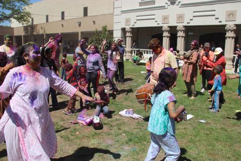 Holi attendees dance to traditional music at the DFW Hindu Temple on Sunday. According to Houston Holi 2016, “The sound of music and drums resonates through the air and everyone dances in celebration throwing color on their beloved, just as Lord Krishna did with his lover Radha.”