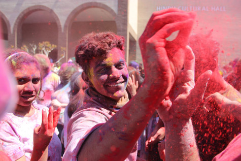 Coppell High School senior Asu Dhakal throws the his magenta Holi powder during Holi on Sunday at the at the DFW Hindu Temple. “[My first Holi experience] has been so much fun, it’s so crazy and completely unlike anything else,” Dhakal said.