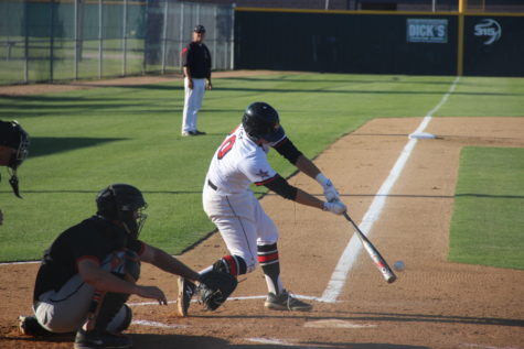 Junior catcher Holden Rupley singles in the second inning of the first game of the doubleheader played against the Haltom Buffalos at the Coppell ISD Baseball/Softball Complex. The Cowboys defeated Haltom in both games with scores of 10-0 and 12-1 to clinch the title of District 7-6A champions.