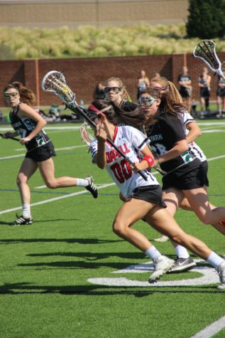 Coppell High School senior Kailey Rivera runs with the ball down the field while being defended by Cedar Park player. Coppell defeated Cedar Park 20-2 and continue onto the state semi-finals. Photo by Megan Winkle.