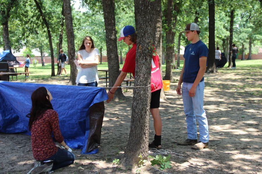 Coppell High School junior Gracie Webb, junior Regan Russell, senior Ryan Hockemeyer and senior Trevor Onstott (left to right) learn how to build a tent during Bill Parker’s fifth period Outdoor Adventures class on Wednesday. The classes are learning techniques such as building tents and archery in order to be able to survive in the wilderness.
