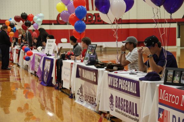 Coppell High School athletes attend signing day to commit to their athletic careers in the future. Fourteen senior athletes signed with 12 different colleges on Wednesday in the large gym. 
