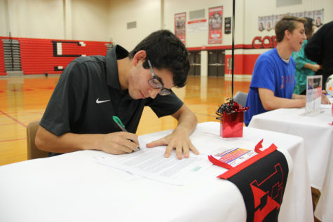 Coppell soccer player Rodrigo Zuniga signs his letter of intent to play at Haverford College. Zuniga was one of six Coppell boys soccer players to sign to a college. Photo by Ale Ceniceros.