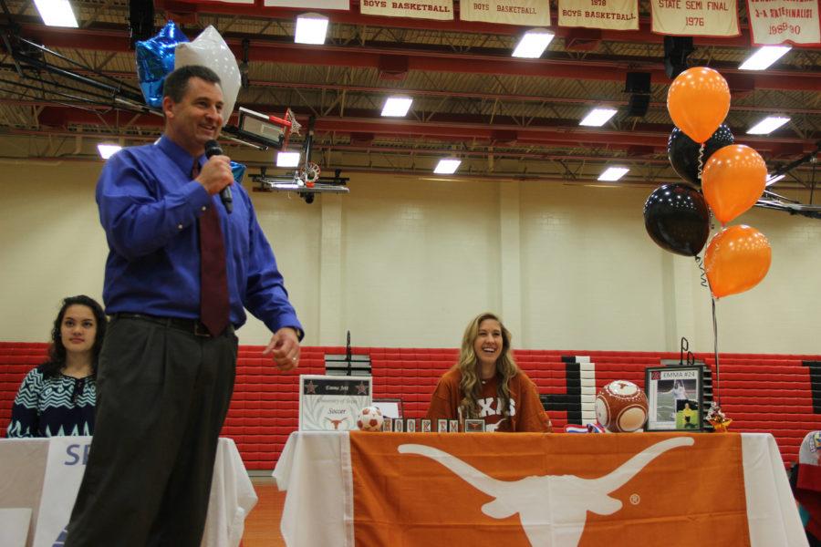 Senior girls soccer player Emma Jett laughs as former coach Chris Stricker tells a story to the crowd about Jett. Jett signed to play soccer at the University of Texas. Photo by Ale Ceniceros.