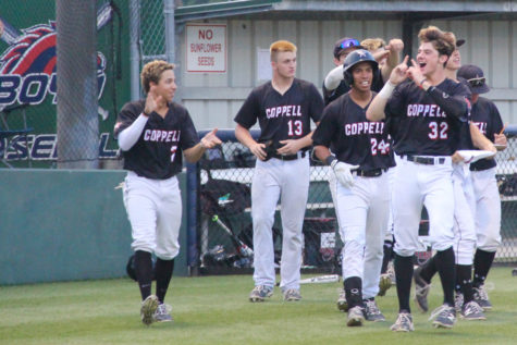 The Cowboys celebrate after scoring a run late in their 10-2 game two victory over McKinney Boyd. After falling in game one, Coppell came back and won by a combined score of 16-2 in the last two games of the series.