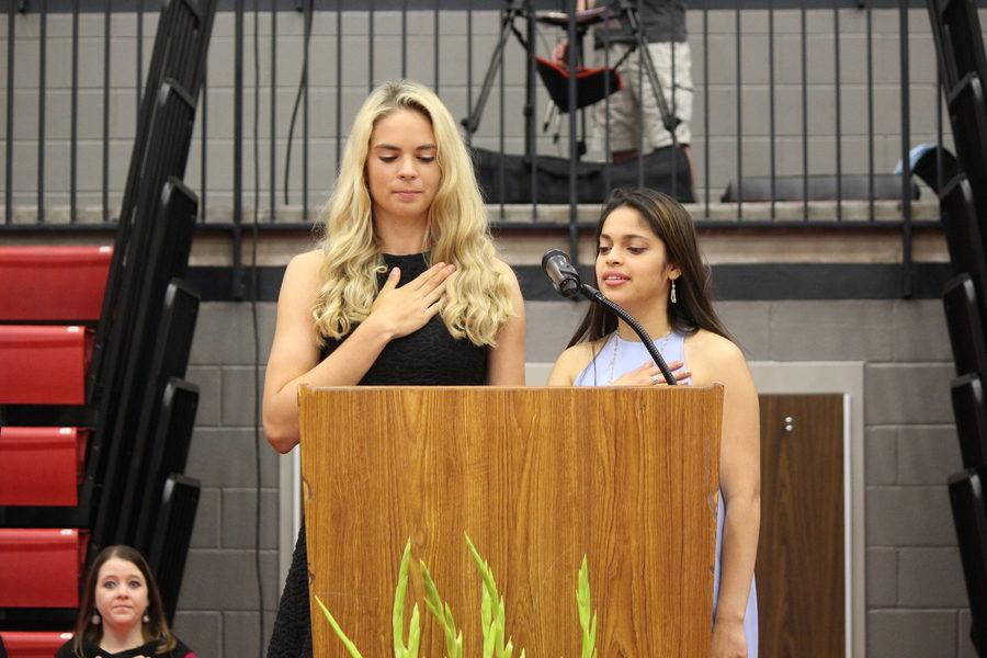 Senior class officers, President Neha Purandare and Vice President Morgan Widner, recite the pledge at the beginning of the senior awards ceremony on Wednesday morning. Seniors received awards and scholarships during the ceremony which took place in the CHS arena. 
