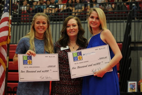 Seniors Linda Castranova and Maddy Giddens are presented with scholarships during the senior awards ceremony on Wednesday morning in the CHS arena. The senior class received over $20 million in scholarships. 