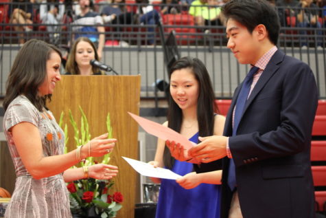 Senior class officers, Secretary Taeeun Kim and Treasurer Eugene Ha, receive scholarships during the senior awards ceremony on Wednesday morning in the CHS arena. The senior class received over $20 million in scholarships. 