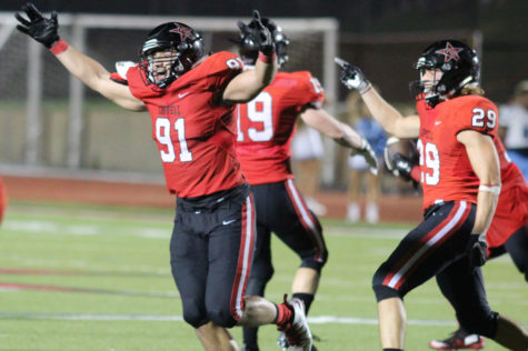 All of the Coppell Cowboys celebrate after forcing a fumble to end Friday night’s game at Buddy Echols Field. After going into overtime, the Coppell Cowboys ended the night with a final score of 28-21, defeating the L.D. Bell Raiders. Photo by Amanda Hair.