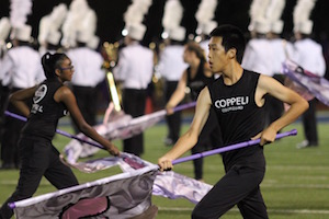New Tech High @ Coppell senior and color guard member Dennis Shen performs in the halftime show during Friday night’s football game against McKinney Boyd at Ron Poe Stadium. Shen was involved in band for 6 years before joining color guard for the 2016-2017 school year. Photo by Amanda Hair.