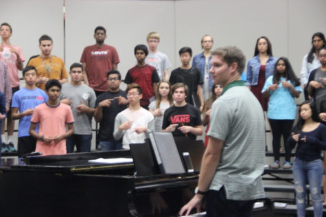  Coppell High School choir associate director Adam Gilliland warms up with the A Capella choir during Josh’s Brown fifth period class. A big competition (Texas Music Educators Association) takes place this February, Gilliland helps Brown and the choir to be successful. Photo by Ale Ceniceros