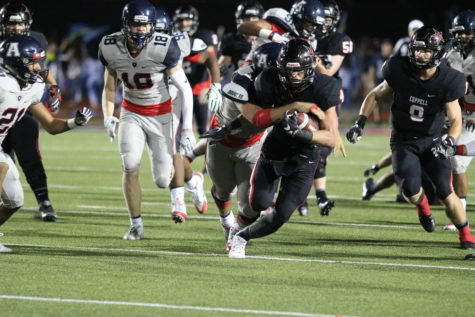 Coppell High School sophomore running back and center T.J. McDaniel is tackled by Allen defensive line, Cole Maxwell, as he runs the ball down the field during the second quarter of Friday night’s game to the Allen Eagles at Buddy Echols Field. The Coppell Cowboys ended the night with a 42-20 loss to the Eagles. 