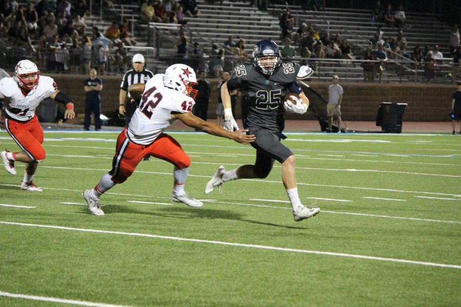 Junior running back Hank Clements evades junior linebacker Thomas Edwards in Coppells 41-10 defeat to Jesuit on Friday night. The Cowboy defense allowed 188 rush yards on the evening.