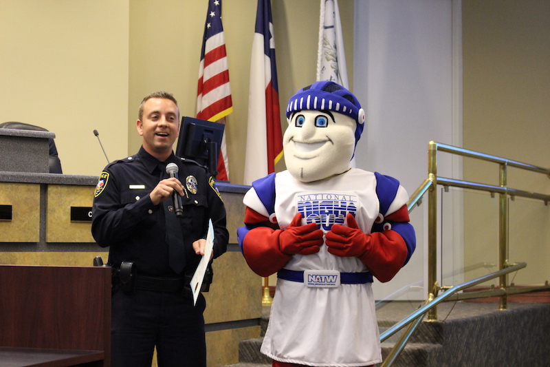 Coppell police officer Peter Dierks and the National Night out knight accept the proclamation to declare Oct. 4 National Night Out. Coppell Police Department will be hosting several block parties throughout the city to celebrate the event. 