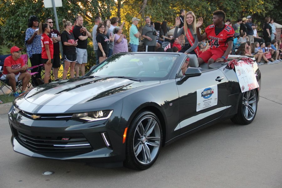 Coppell High School junior homecoming nominees Margaret Lazaroski and TJ Andres drive through the parade on Wednesday to represent the 11th grade homecoming court. All CHS students are asked to participate in the voting of the homecoming court elections.
