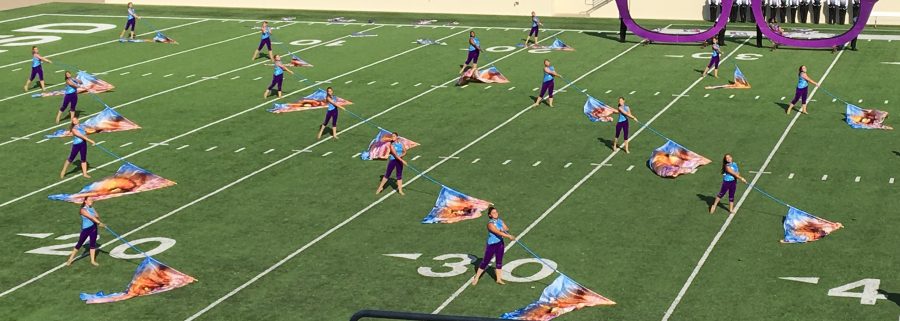 The Coppell color guard performing with giant blue flags during the ballad of the show at prelims for the USBANDS Regional Championships. The band received a score of 83.550 winning at C.H. Collins Athletic Complex in Denton on Saturday afternoon.