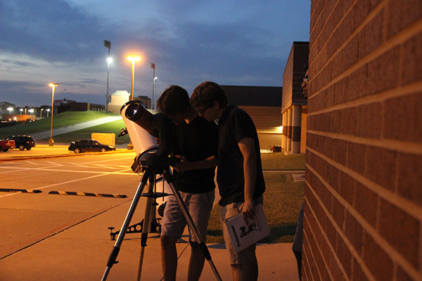 Coppell High School students look through  the telescope the science department has named ‘the Beast’ on Sept 21 in the CHS parking lot. Astronomy students taught AP Earth and Science students along with AP Environmental Science classess about different topics relating to the celestial sphere at Mrs. Barnes Star Party.