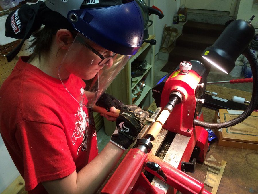 Coppell High School junior Emily Evans works on creating one of her many homemade wooden pens. Evans has been making unique pens since her 16th birthday after receiving a lathe, which is a device that is used to shape wood while being rotated on an axis. Photo courtesy Emily Evans. 