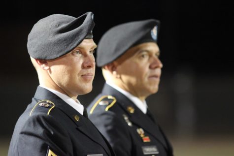Captain Robert Bright and Captain Alex Torres watch Friday night's football game against Allen from the Buddy Echols Field sidelines. The military representatives were invited from Lewisville Recruiting Center to be recognized for Military Appreciation Night.