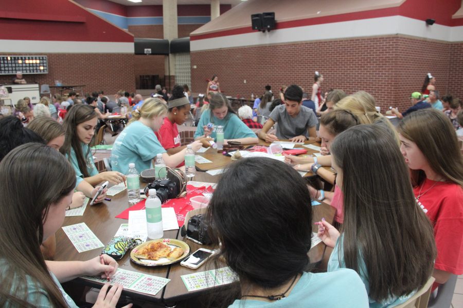 A+table+full+of+Coppell+High+School+students+concentrating+hard+on+the+numbers+on+their+bingo+cards.+Friday+night+Coppell+Cowgirls+cheerleaders+held+their+annual+Cheer+Bingo+in+the+cafeteria.+Photo+by+Katie+Wiener.