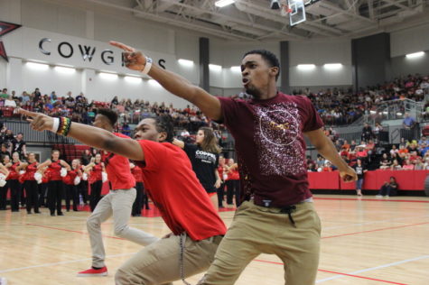 Coppell High School seniors Christian McDow and Devon Hawkins pose and point to the crowd as they end their dance routine at the pep rally against the Allen Eagles last Friday in the arena. Both have a pursuit in break dancing and seem to complete difficult looking tasks and moves while other audience members like to jump in and join. Photo by Hannah Tucker.