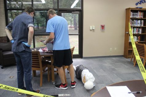 Coppell High School seniors take pictures of the clues they found of the crime during Sandy Kirkpatrick’s third period forensics science class on Monday. After figuring out clues they are required to do a diagram and a chart, the student were required to write a conclusion.