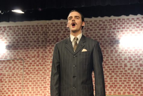 Coppell High School theater senior Ty Dalrymple sings a portion of a song from the Coppell Theater’s current musical, 42nd Street, as a microphone check before the dress rehearsal begins Monday after school in the theater. Ty and and Jack Dalrymple are both playing lead roles in this new musical, which will be premiering Oct. 29-30 and Nov. 5-6. Photo by Hannah Tucker.