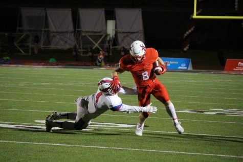 Sophomore wide receiver Blake Jackson breaks a tackle on his way to a 37-yard touchdown catch. Jackson was again the leading receiver for the Cowboys, finishing with five catches for 93 yards and two touchdowns.