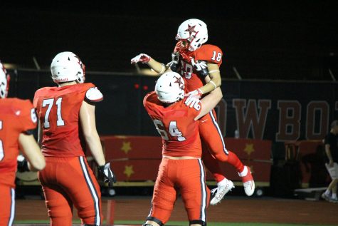 Senior wide receiver Matt Dorrity is lifted up by sophomore lineman Trevor Stange after Dorrity's 55-yard touchdown catch in Coppell's 48-13 win over Richardson Pearce. Dorrity's touchdown put the Cowboys up 28-3 over the Mustangs early in the second quarter.