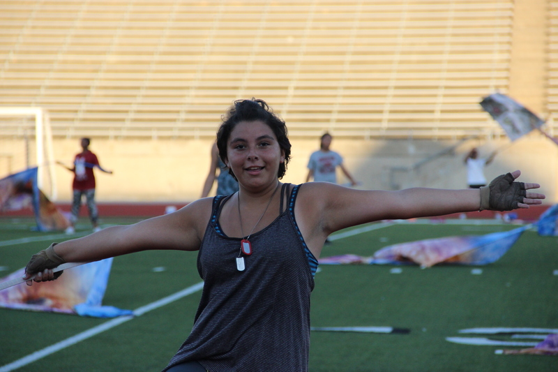 Coppell High School sophomore Delaney Bell reviews her choreography and performance technique for the marching show late Wednesday afternoon at Buddy Echols Field. Bell is on the weapon line for the color guard, which is a section of the guard consisting of all advanced vets who spin weapons such as a sabre and rifle. Photo by Hannah Tucker.