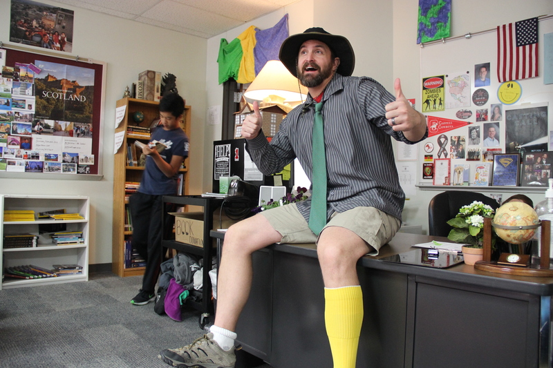 Coppell High School history teacher Andrew Patterson shows off his mismatched outfit for Red Ribbon Awareness week in his classroom on Monday. “I got dressed in the dark and thought I was dressed professionally, but I made a mistake,” Patterson sincerely remarks. Photo by Hannah Tucker.