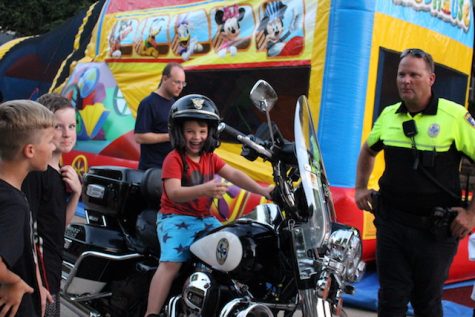 Young children play on inflatable slides at the National Night Out social on Pecan Hollow Drive. On Tuesday, Coppell celebrated its thirty-third annual NNO, which promotes neighborhood safety.