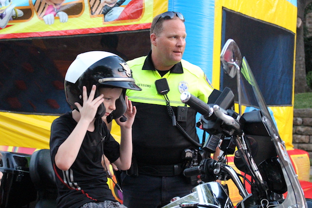 Young children play on inflatable slides at the National Night Out social on Pecan Hollow Drive. On Tuesday, Coppell celebrated its thirty-third annual NNO, which promotes neighborhood safety.