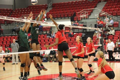 Coppell High School sophomore Amarachi Osuji tips the ball during the second set of the game Friday in the CHS arena. After three sets of playing Friday night the Cowgirls took the victory and won all three sets. 