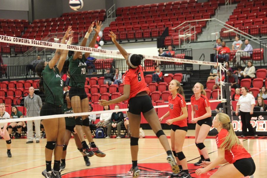 Coppell High School sophomore Amarachi Osuji tips the ball during the second set of the game Friday in the CHS arena. After three sets of playing Friday night the Cowgirls took the victory and won all three sets.
