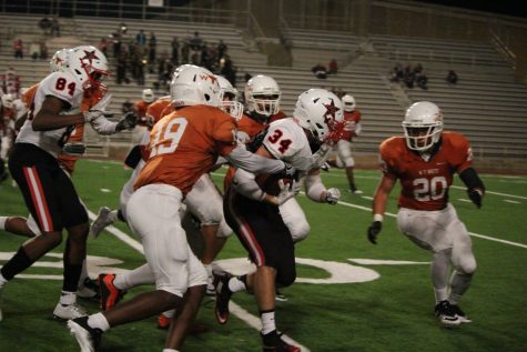 Senior running back Thomas Donaldson fights through defenders on a run in the fourth quarter. Donaldson had 33 total yards in Coppell's 40-14 win over W.T. White. Photo by Kelly Monaghan.