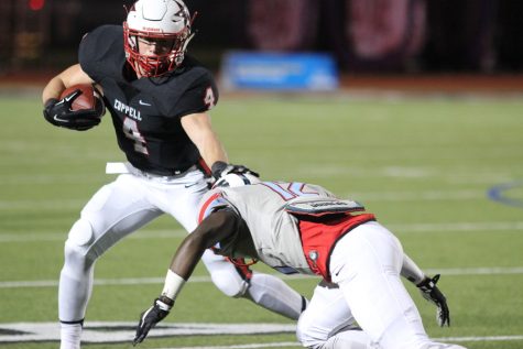 Coppell High School sophomore running back T.J.McDaniel dodges a tackle from Dallas Skyline senior cornerback Eric Green during Friday’s senior night game against the Raiders at Buddy Echols Field. The Cowboys hosted the Raiders in their final home game of the season and defeated them 24-14. 