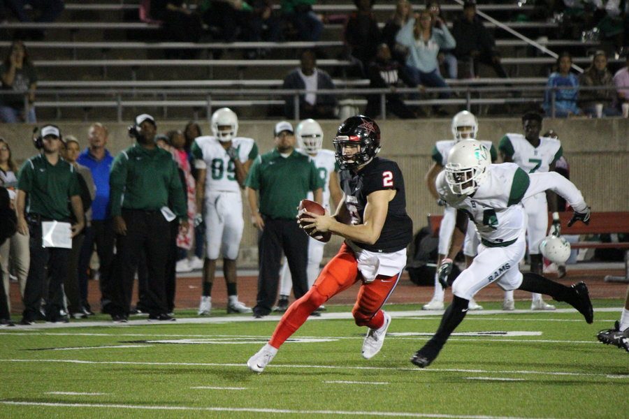 Coppell High School junior Brady McBride carries the ball past the Berkner defense Friday night at Buddy Echols Field. The Cowboys beat Berkner 42-7 to move to 4-1 in District 9-6A play.