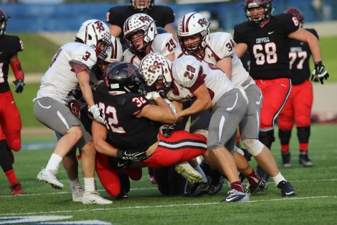 Coppell High School senior Bernardo Rodriguez gets tackled by multiple Round Rock players at the third quarter comes to a close at WISD Stadium. Round Rock ended the night with a 49-45 victory over Coppell, ending the Coppell Cowboys’ season. 