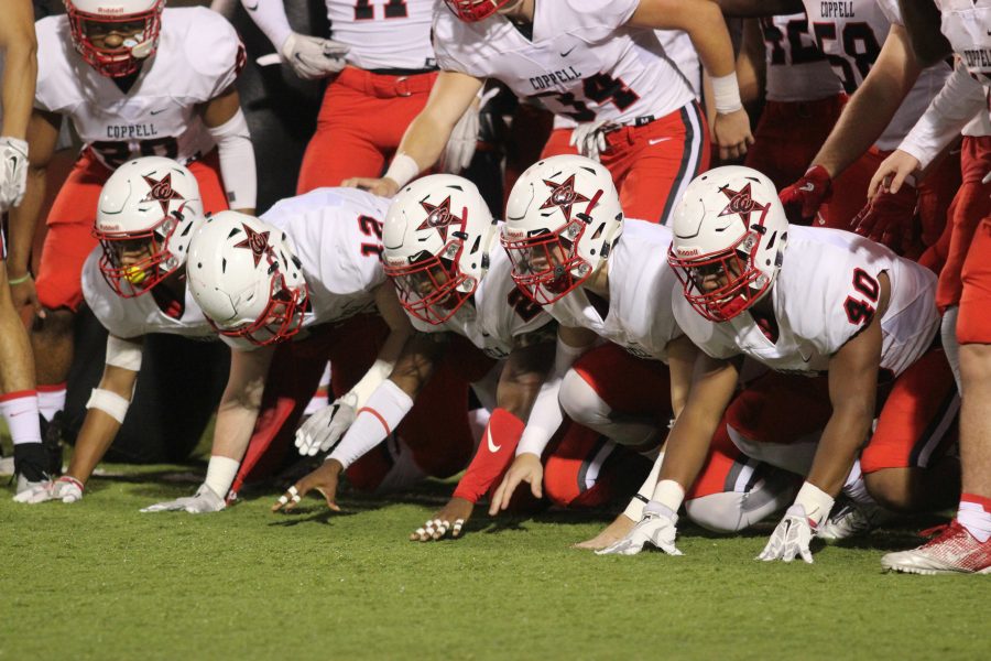 The Cowboys line up to run through the helmet prior to their 52-0 blowout of Richardson in the final regular season game. Coppell heads into the playoffs riding a six game win streak.