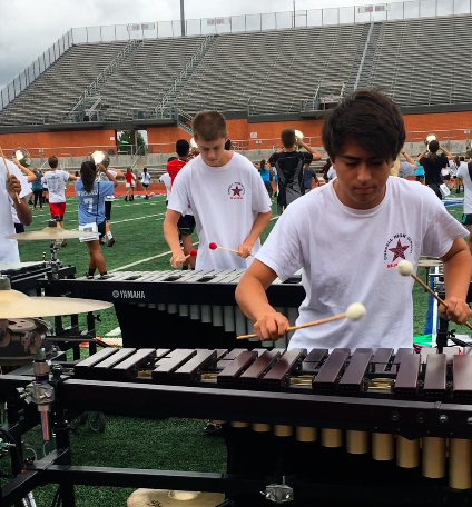 Coppell High School junior John Coffee rehearses with front ensemble on Tuesday, Nov. 7 in San Antonio. Coppell marching band's preparation helped them to secure a spot in state finals. Photo by Amelia Vanyo.