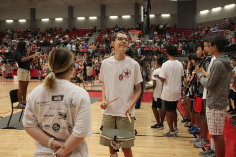 Coppell High School sophomore Daniel Cervantes plays his drum practice pad at the senior pep rally in the arena last Friday. Cervantes is a member of the Coppell Band and always shows his spirit through his drumming skill. Photo by Hannah Tucker.