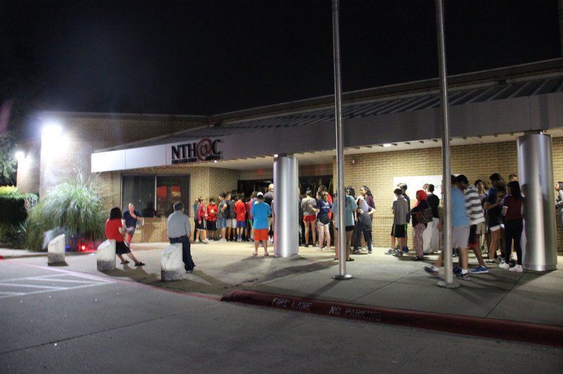 Coppell ISD students wait outside New Tech High@Coppell to enter the annual haunted house on Thursday, Oct. 27. The haunted house included themed rooms with clowns and other scary figures. Photo by Hannah Tucker.