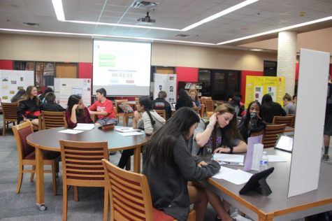 During Coppell High School teacher and coach Nick Benton’s third period World Geography class on Tuesday, students learn about the Mayan culture. Students moved around the library to see different presentations and wrote down the many different things they learned from their peers. 