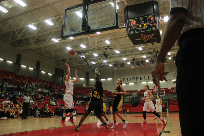 Coppell High School senior Rachel Crutchfeild shoots for a basket during the second quarter of last nights game, despite being blocked by Forney player Briasia Willie in the CHS arena. The Coppell Cowgirls ended the game with a final score of 56-29, beating the Forney Lady Jackrabbits.
