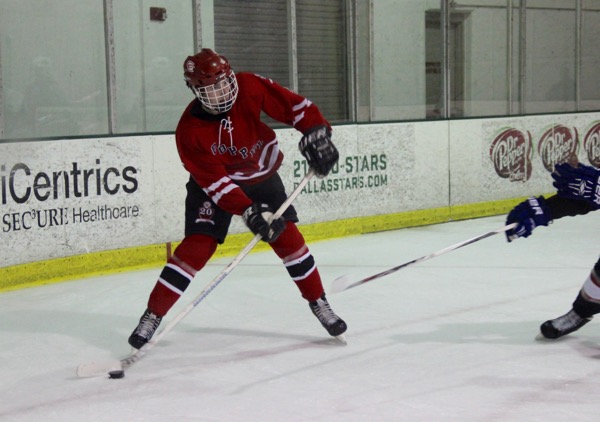 Coppell High School senior forward James Reeman looks to pass to a teammate during the first period of yesterday at the Dallas Starcenter in Farmers Branch. Reeman assisted on Coppell’s only goal in a 4-1 loss to Frisco.