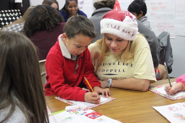Coppell High School junior Grace Mobley helps Cottonwood Creek elementary first grader write a letter to Santa on Friday during Tracy Hensons second period AP English III class.