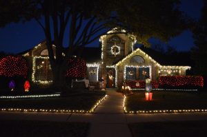 The Hills' home lights up a small Coppell neighborhood. Their home includes lights on the roof, bushes, and yard, and cost approximately $500.